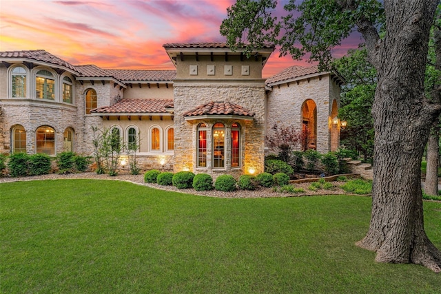 620 Timber Creek Cir, Stephenville, TX 76401 - rear view of property with stone siding, a yard, and a tiled roof