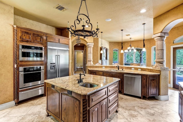 620 Timber Creek Cir, Stephenville, TX 76401 - kitchen featuring a warming drawer, arched walkways, a sink, stainless steel appliances, and recessed lighting