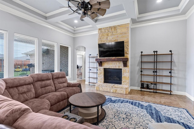 3102 White Horse Ct, Granbury, TX 76049 - living room with ceiling fan, coffered ceiling, crown molding, arched walkways, and a stone fireplace
