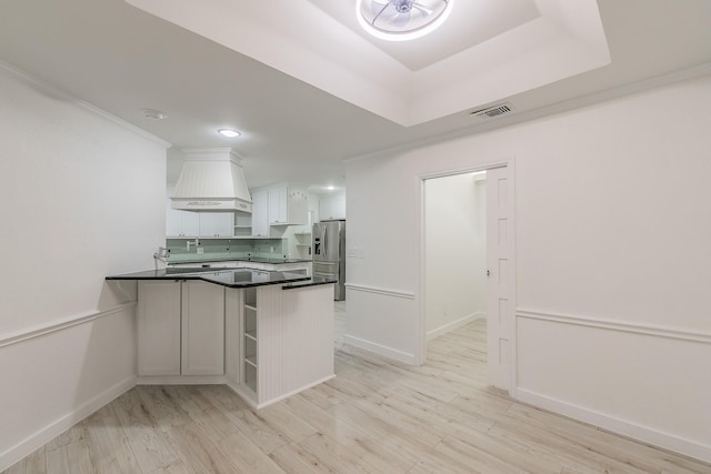4107 Crossgate Ct, Arlington, TX 76016 - kitchen with dark countertops, stainless steel fridge with ice dispenser, a peninsula, custom exhaust hood, and white cabinetry