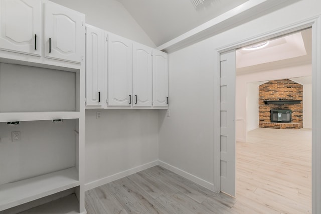 4107 Crossgate Ct, Arlington, TX 76016 - laundry area featuring light wood-type flooring, a fireplace, and baseboards