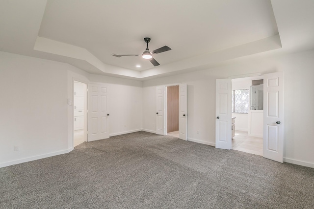 4107 Crossgate Ct, Arlington, TX 76016 - unfurnished bedroom featuring a tray ceiling, carpet flooring, baseboards, and a ceiling fan