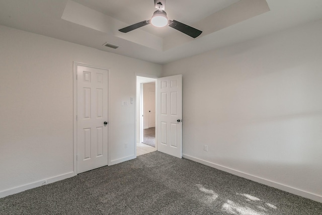 4107 Crossgate Ct, Arlington, TX 76016 - spare room with a tray ceiling, carpet, a ceiling fan, and baseboards