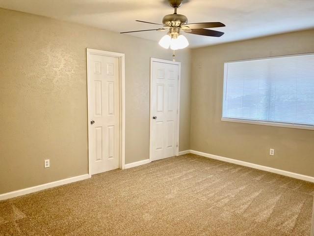 5636 Cherilee Ln, Haltom City, TX 76148 - carpeted empty room with ceiling fan and baseboards