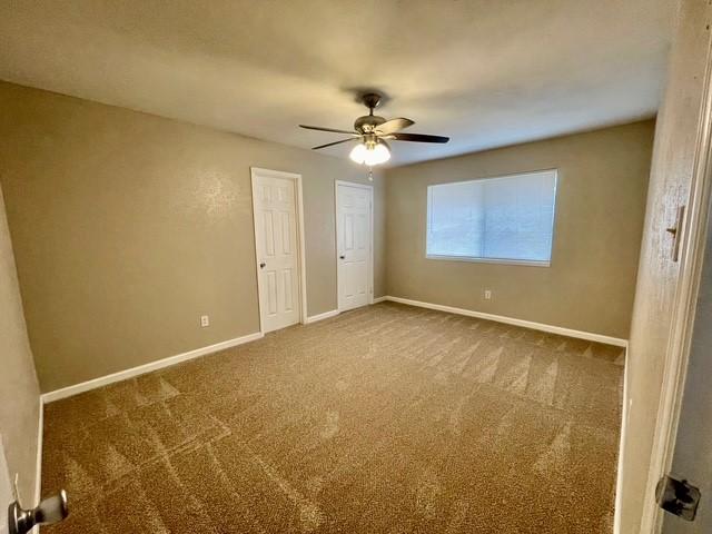 5636 Cherilee Ln, Haltom City, TX 76148 - carpeted empty room with baseboards and a ceiling fan