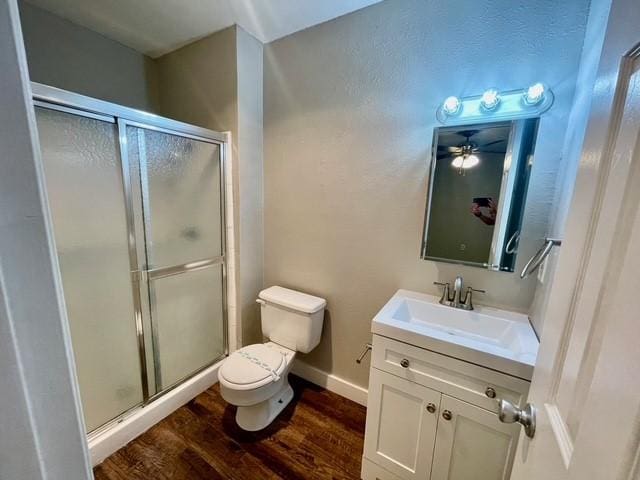 5636 Cherilee Ln, Haltom City, TX 76148 - bathroom with wood finished floors, a stall shower, toilet, and vanity