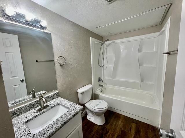 5636 Cherilee Ln, Haltom City, TX 76148 - full bathroom with a textured wall, wood finished floors, a textured ceiling, toilet, and vanity