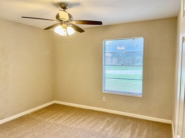 5636 Cherilee Ln, Haltom City, TX 76148 - carpeted empty room with baseboards and ceiling fan