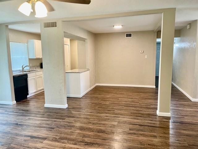 5636 Cherilee Ln, Haltom City, TX 76148 - empty room with a ceiling fan, dark wood-style floors, baseboards, and a sink