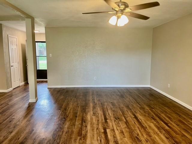 5636 Cherilee Ln, Haltom City, TX 76148 - empty room with a ceiling fan, dark wood-type flooring, and baseboards