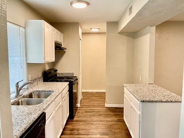 5636 Cherilee Ln, Haltom City, TX 76148 - kitchen featuring black appliances, a sink, under cabinet range hood, dark wood-style floors, and light stone counters