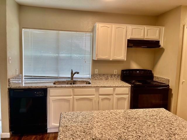 5636 Cherilee Ln, Haltom City, TX 76148 - kitchen with black appliances, under cabinet range hood, a sink, white cabinets, and light stone countertops