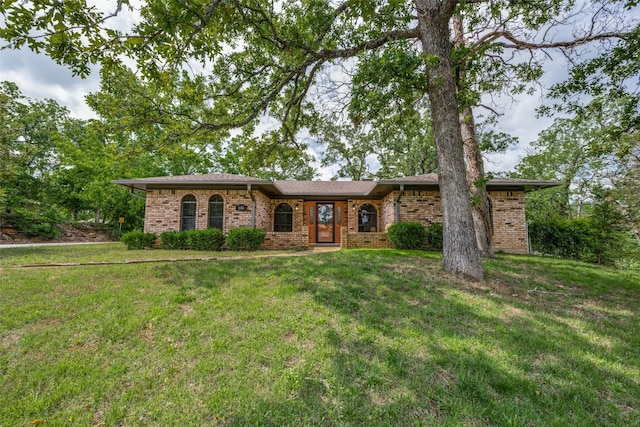 146 Circle Dr, Denison, TX 75021 - ranch-style home with brick siding and a front yard