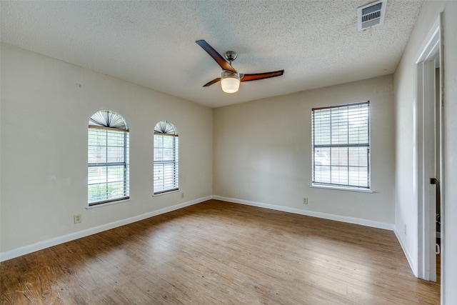 146 Circle Dr, Denison, TX 75021 - spare room with a ceiling fan, healthy amount of natural light, a textured ceiling, and wood finished floors