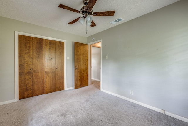 146 Circle Dr, Denison, TX 75021 - unfurnished bedroom with carpet floors, a closet, baseboards, ceiling fan, and a textured ceiling