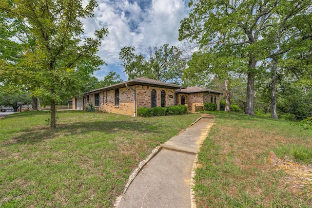 146 Circle Dr, Denison, TX 75021 - single story home featuring brick siding, a front lawn, and an attached garage