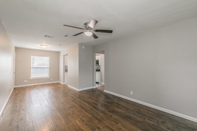 1209 Ralph St, Grand Prairie, TX 75051 - empty room featuring dark wood-style floors, ceiling fan, and baseboards