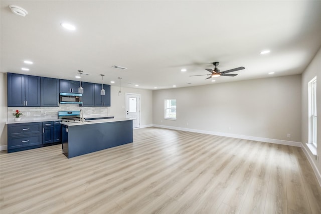 1218 Ralph St, Grand Prairie, TX 75051 - kitchen with appliances with stainless steel finishes, recessed lighting, light countertops, blue cabinets, and a ceiling fan