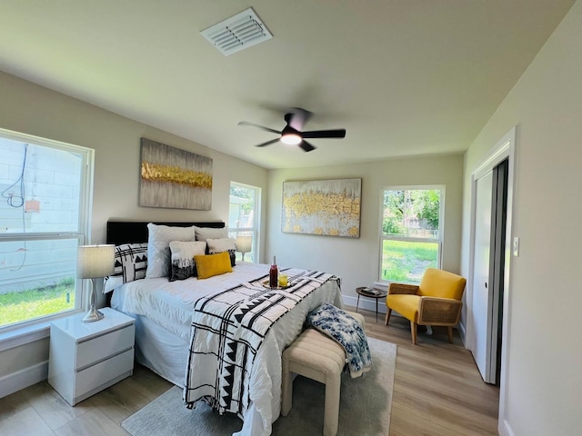1218 Ralph St, Grand Prairie, TX 75051 - bedroom featuring multiple windows, light wood-style flooring, and ceiling fan