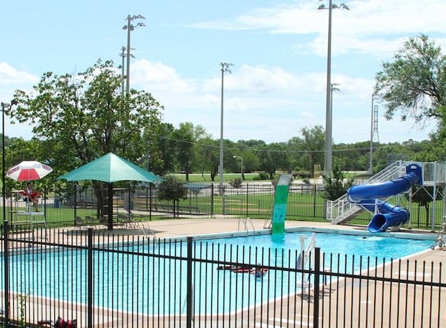 1218 Ralph St, Grand Prairie, TX 75051 - community pool featuring a water slide and a patio