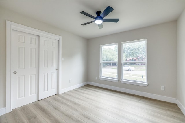 1218 Ralph St, Grand Prairie, TX 75051 - unfurnished bedroom with light wood-type flooring, a closet, baseboards, and ceiling fan