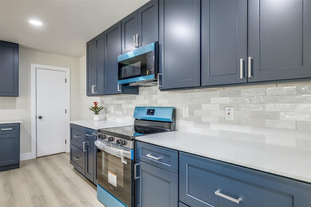 1218 Ralph St, Grand Prairie, TX 75051 - kitchen featuring appliances with stainless steel finishes, backsplash, light wood-style floors, light countertops, and recessed lighting