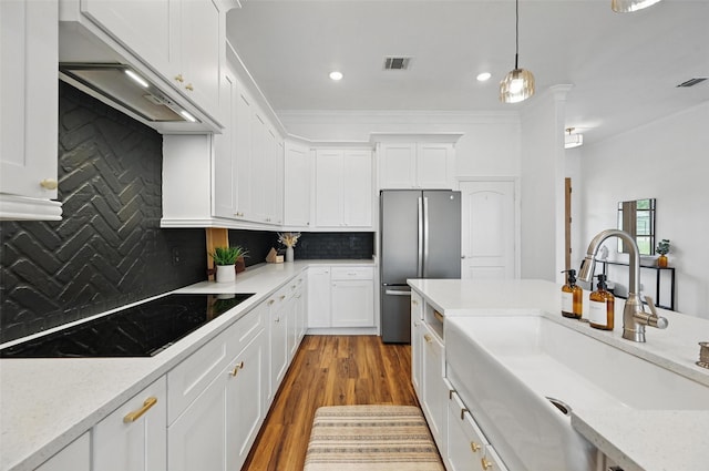 917 County Road 914, Burleson, TX 76028 - kitchen featuring freestanding refrigerator, a sink, white cabinets, black electric stovetop, and ornamental molding
