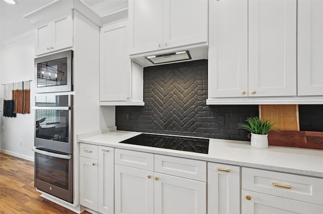 917 County Road 914, Burleson, TX 76028 - kitchen with black electric stovetop, stainless steel double oven, tasteful backsplash, white cabinetry, and built in microwave