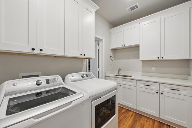 917 County Road 914, Burleson, TX 76028 - laundry area featuring washer and dryer, cabinet space, and light wood finished floors