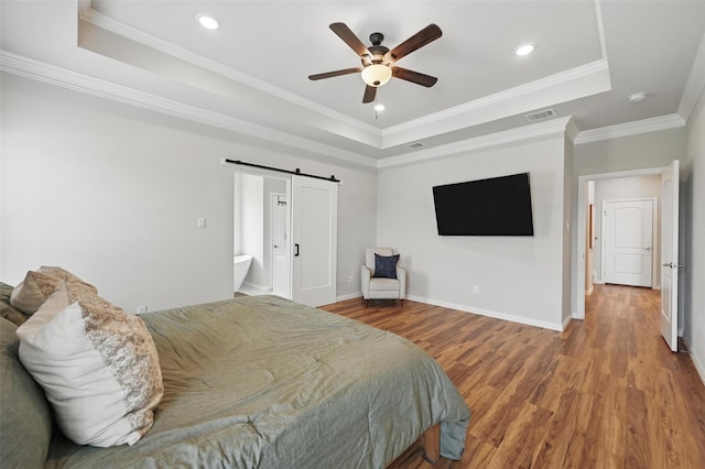 917 County Road 914, Burleson, TX 76028 - bedroom with a tray ceiling, a barn door, wood finished floors, baseboards, and recessed lighting