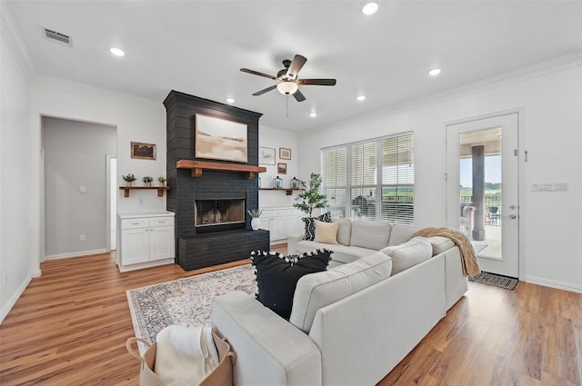 917 County Road 914, Burleson, TX 76028 - living area with a ceiling fan, light wood-type flooring, ornamental molding, a brick fireplace, and recessed lighting