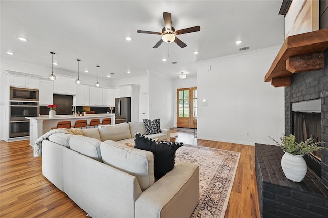 917 County Road 914, Burleson, TX 76028 - living room featuring ceiling fan, recessed lighting, baseboards, light wood-style floors, and ornamental molding