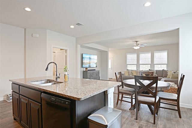 3454 Eloise Ln, Krum, TX 76249 - kitchen with dishwasher, a sink, light wood-style floors, open floor plan, and light stone counters