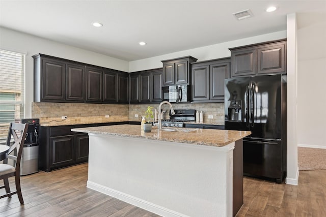 3454 Eloise Ln, Krum, TX 76249 - kitchen with black appliances, light wood-type flooring, backsplash, light stone countertops, and recessed lighting