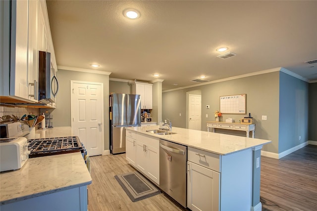 1908 Damianita Dr, Royse City, TX 75189 - kitchen with appliances with stainless steel finishes, a sink, ornamental molding, backsplash, and light wood finished floors