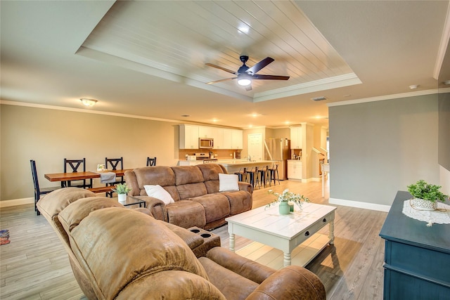 1908 Damianita Dr, Royse City, TX 75189 - living area featuring a raised ceiling, baseboards, light wood finished floors, a ceiling fan, and crown molding