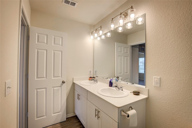 1908 Damianita Dr, Royse City, TX 75189 - bathroom featuring a textured wall, double vanity, and wood finished floors