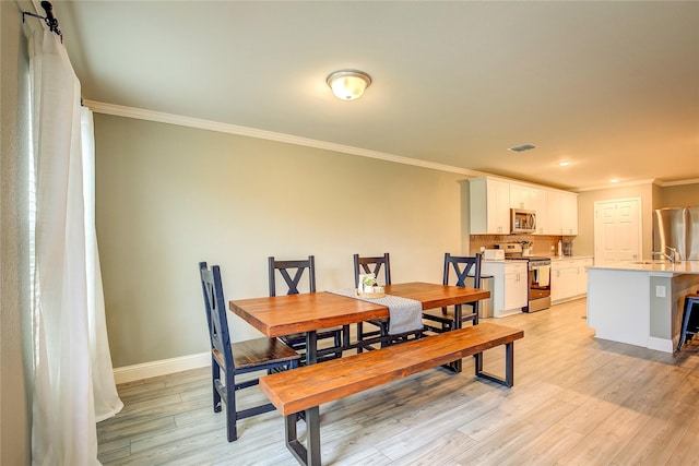 1908 Damianita Dr, Royse City, TX 75189 - dining area with crown molding, light wood-style floors, and baseboards