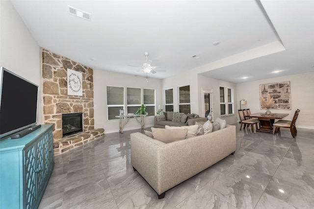 8109 Brahmin Ct, Fort Worth, TX 76131 - living room with ceiling fan, marble finish flooring, a stone fireplace, and baseboards