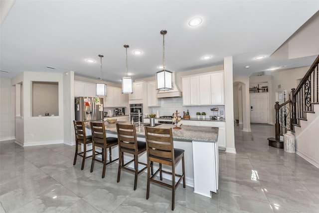 8109 Brahmin Ct, Fort Worth, TX 76131 - kitchen featuring stainless steel appliances, custom exhaust hood, light marble finish floors, arched walkways, and baseboards
