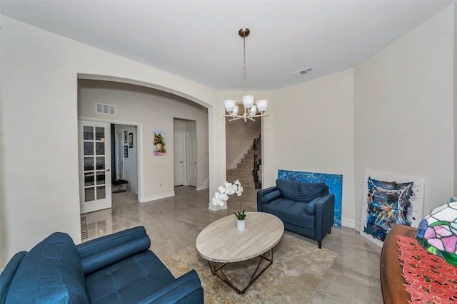8109 Brahmin Ct, Fort Worth, TX 76131 - living room with a chandelier, arched walkways, stairs, and baseboards