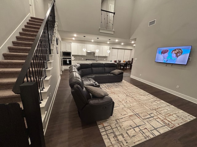 3121 Althea St, Mckinney, TX 75071 - living area with dark wood-style floors, stairs, and baseboards