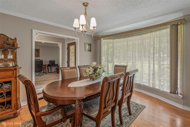 dining room with a chandelier, crown molding, a textured ceiling, light wood-style floors, and a desk