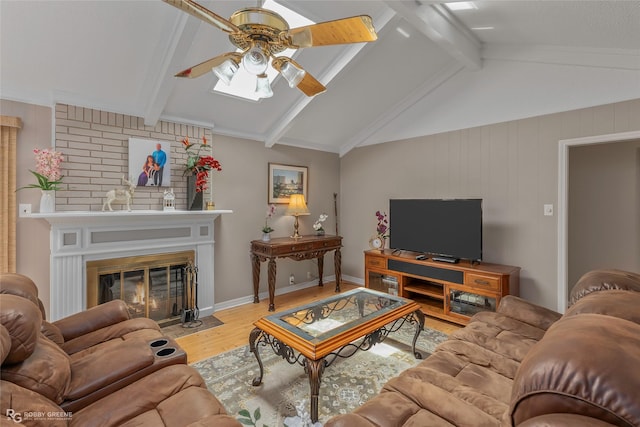 living area with wood finished floors, ceiling fan, a fireplace, and wood walls