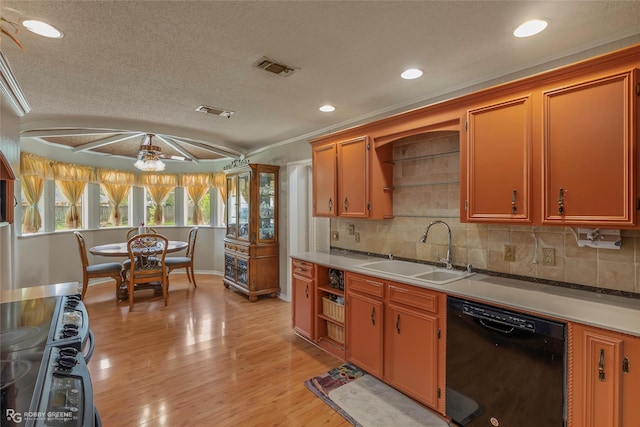 kitchen featuring a sink, black dishwasher, light wood finished floors, backsplash, and recessed lighting