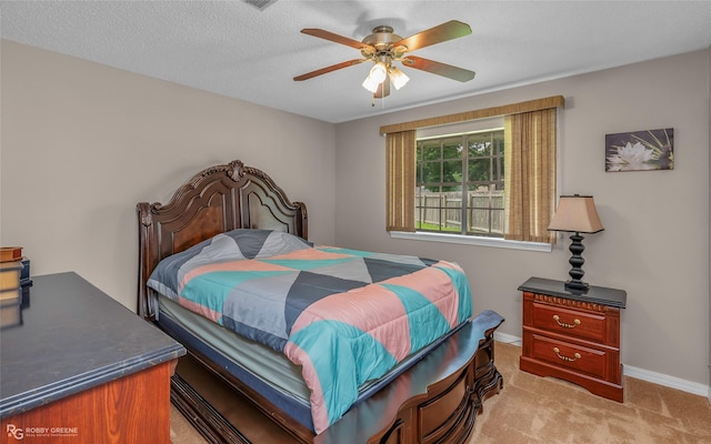 bedroom with light colored carpet, baseboards, and ceiling fan