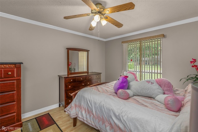bedroom with light wood-style flooring, crown molding, a textured ceiling, ceiling fan, and baseboards