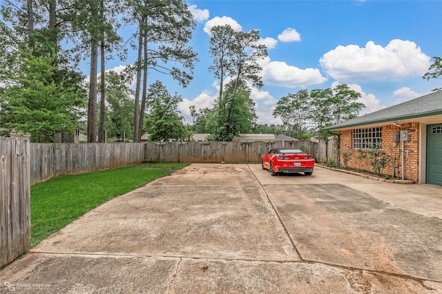 view of parking featuring concrete driveway