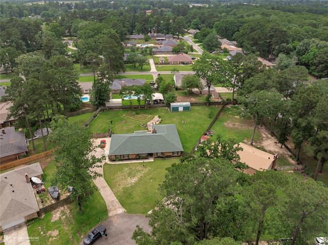 aerial view of property's location with nearby suburban area and a forest