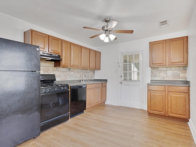 511 Wildwood Dr, Mesquite, TX 75149 - kitchen with black appliances, under cabinet range hood, a ceiling fan, tasteful backsplash, and light wood-style floors